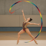 Gimnasta ejecutando lanzamiento de cinta